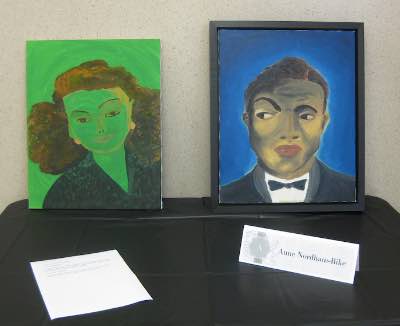 Photo from exhibit of Green Rita portrait of Rita Hayworth and Portrait of Nat King Cole